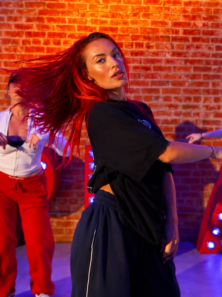 LaTina Rusin dancing with other performers during a group session
